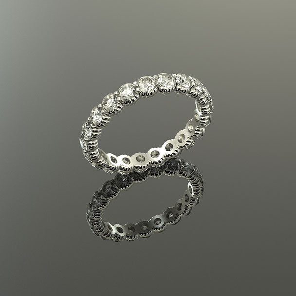 18K white gold natural diamond eternity ring band pictured on a reflective surface.